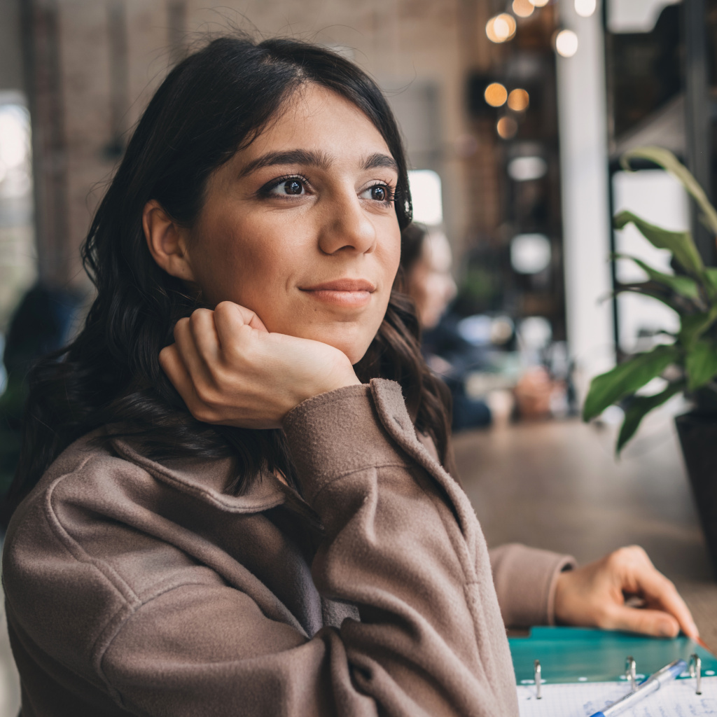 A woman looking off into the distance, in contemplation but with a hopeful gaze.